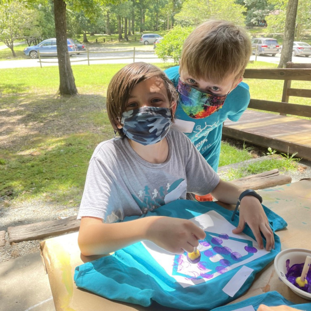 Two children making a VBS craft