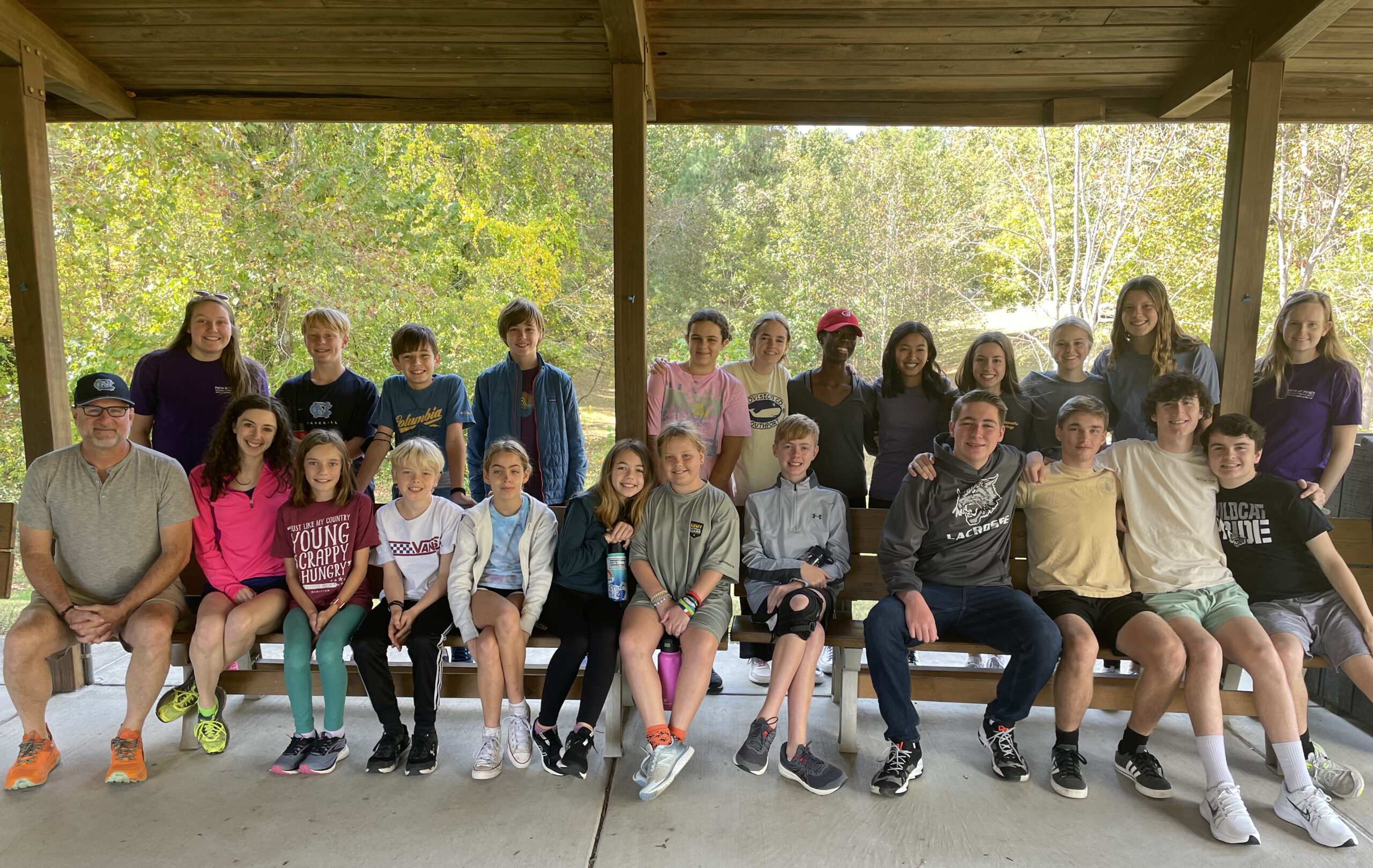 A group of teenagers together at a youth group event, smiling