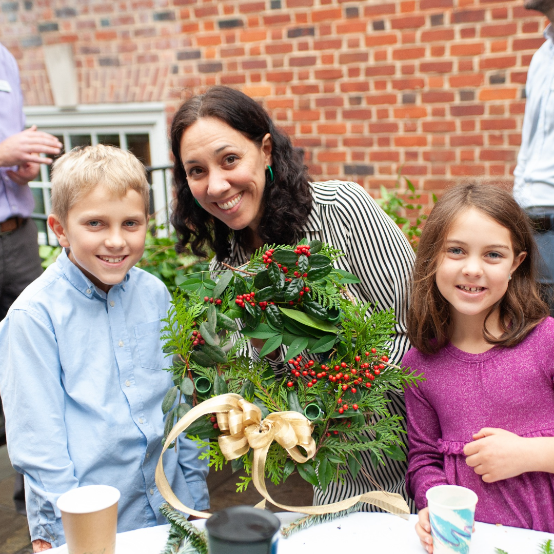 A mother and her two children show off the Advent wreath they made