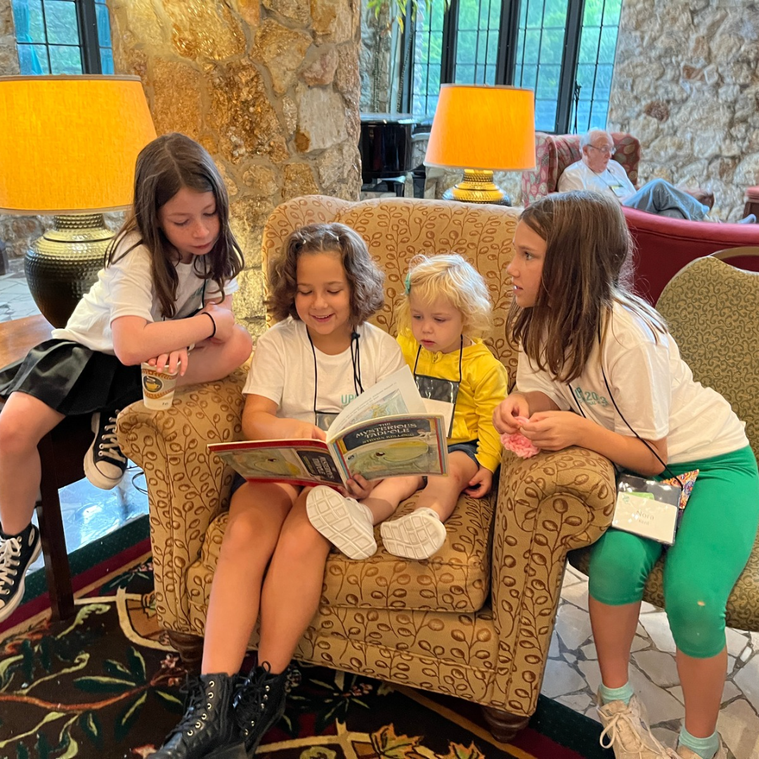 Children sit together reading